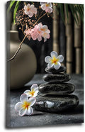 A harmonious black stone stack paired with white and pink flowers bamboo and ceramic vases creates a tranquil Zen decor for minimalist homes and mindful spaces 24x36in Wood Framed
