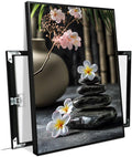 A harmonious black stone stack paired with white and pink flowers bamboo and ceramic vases creates a tranquil Zen decor for minimalist homes and mindful spaces 8x12in Metal blackFramed